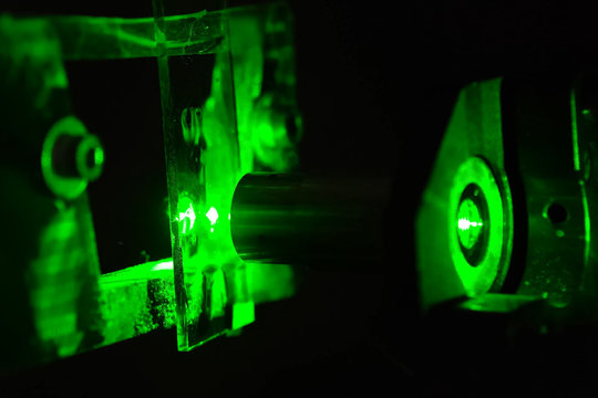 Green light in the laboratory. Green laser in dark.