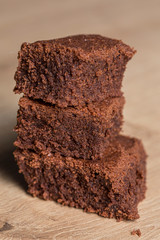Chocolate brownie cake on pieces on a wooden surface