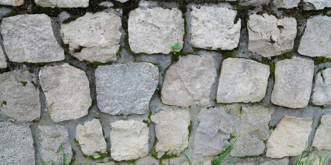 Old weathered brick wall of medieval fortress horizontal wallpaper grunge background