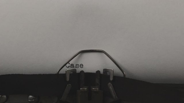 close-up typing a text case study, old vintage typewriter with a sheet of paper
