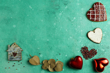 For Valentine's Day. Composition of hearts made of various materials: ceramics, beads, eucalyptus leaves. House with a window in the form of a heart, Horizontal position, top view, copy space.