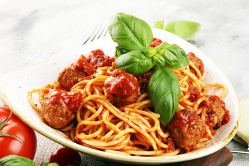 Spaghetti pasta with meatballs and tomato sauce with basil and parmesan