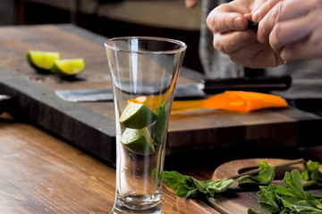 making cocktail of mint and lemon.