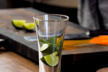 making cocktail of mint and lemon.