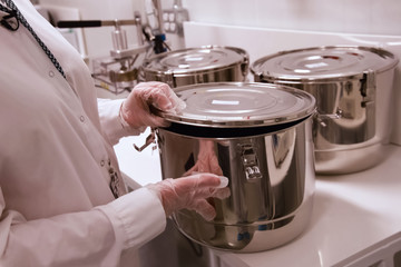 Marijuana in the pan. Cannabis inflorescences in pot in a laboratory.