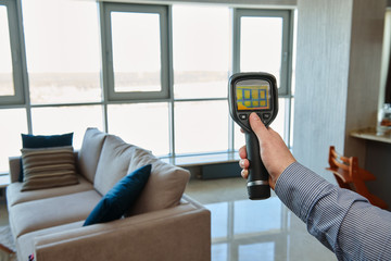 thermal imaging camera at apartment inspection for temperature loss and finding heating leakage