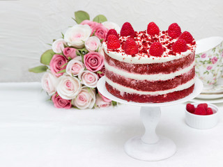 Birthday Drip Cake with roses.  Red cakes with raspberry jelly and white cream.