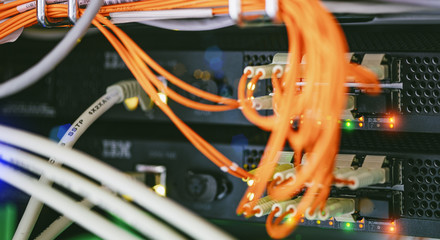 Server units in cloud service data center showing flickering light indicators for massive data...
