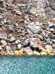 crystal clear turquoise water at the foot of the mountain.