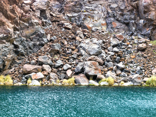 crystal clear turquoise water at the foot of the mountain.