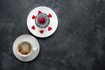 coffee and cherry cheesecake with carved hearts from  red paper on a stone background with copy space for your text. Breakfast concept for a loved one on Valentine's Day