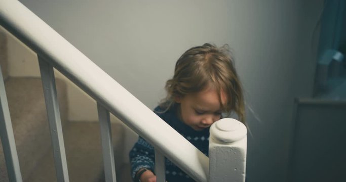 Little toddler on the stairs at home