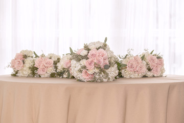 Pink and white roses with white hydrangea bridal party bouquets lined up