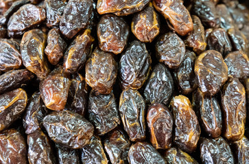 Dried dates scattered on a table on a street market