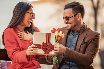 Romantic man giving flowers to his girlfriend