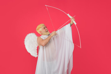 Smiling man in angel costume. February 14. Cupid shoot with bow. Valentines day angel. Cupid angel...