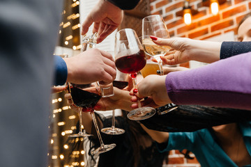 Glasses of champagne in the hands of a group of people in a restaurant