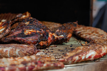 Grilled pork ribs on the grill at street food festival
