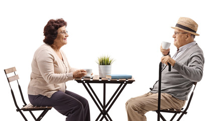 Seniors drinking coffee at a table