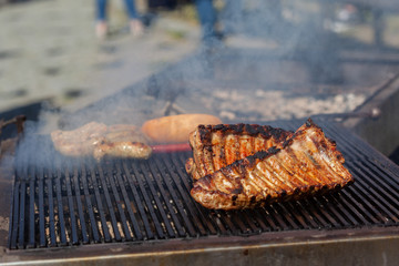 Grilled pork ribs on the grill at street food festival