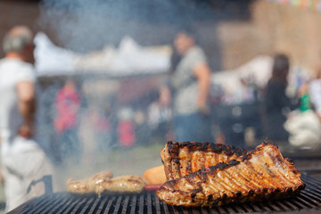 Grilled pork ribs on the grill at street food festival