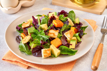 Salad with roast pumpkin , grilled halloumi and avocado