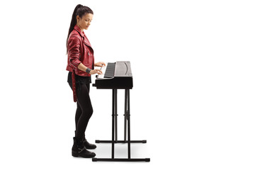 Young woman playing a digital piano