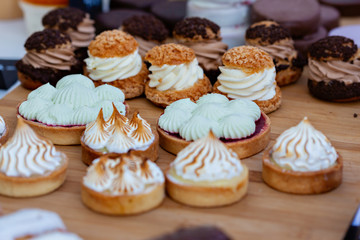 Delicious mini tarts on table outdoor. Street food festival