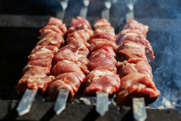 Grilling marinated meat on a grill. Street food festival
