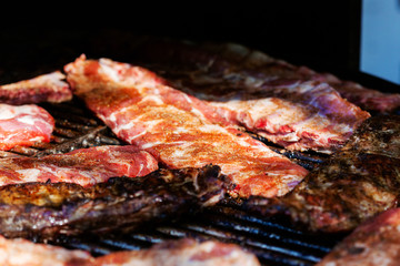 Grilled pork ribs on the grill at street food festival