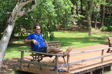 Fototapeta premium man sitting on a bench in the park