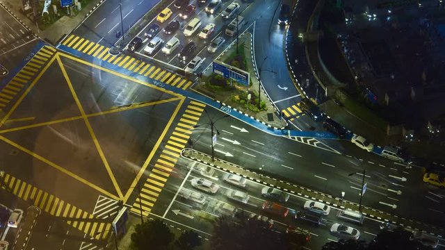 Time lapse of night scene, aerial view of busy junction in Kuala Lumpur, Malaysia. Zoom in