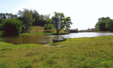 Boat on the grass near the lake