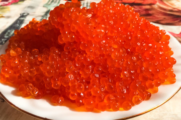 Red caviar on plate on the table. Salmon caviar. Dietary nutriti