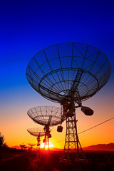 The silhouette of a radio telescope observatory