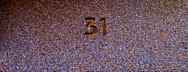 Number 31, thirty-one, embossed in rough dark colorful graduated background.