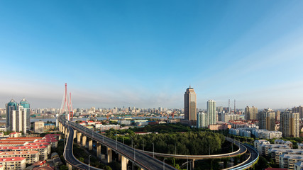 Fototapeta na wymiar Panoramic view of Shanghai Yangpu bridge and cityscapes in sunny day, long time exposure landscape.