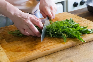 Sliced parsley and dill on board. Greens for the second course.