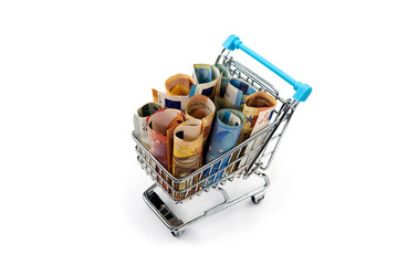 Closeup of a shopping cart full of euro banknotes isolated on white. concept: loan, investment,...