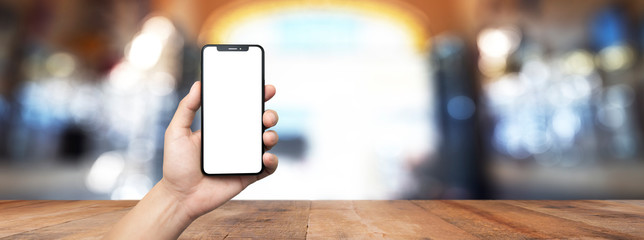 concept - cell phone in hand inside restaurant with white screen - easy modification