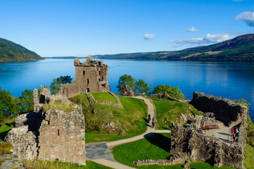 Naklejka premium The ruins of Urquhart Castle on the shore of Loch Ness in Drumnadrochit, Inverness, Scotland (Scottish Highlands) on a beautiful summer day