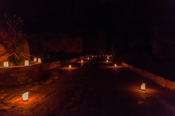 Candels along the Siq (narrow gorge, main entrance to the ancient city Petra) during Petra by...