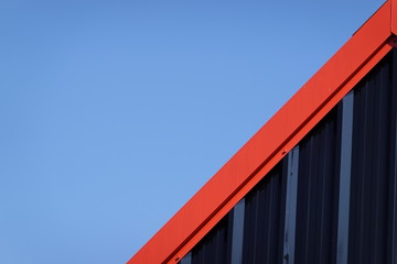 Black and red metal steel plate for background. Blue sky background.