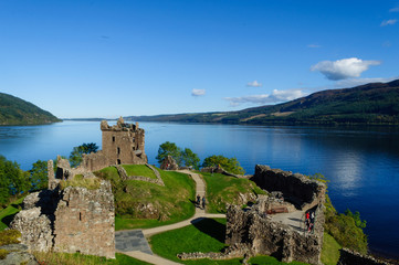 Ruins of Urquhart Castle on the shores of Loch Ness in the Scottish Highlands, with a beautiful blue sky in the summer. Drumnadrochit, Inverness, Scotland