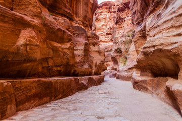 The Siq, narrow gorge, main entrance to the ancient city Petra, Jordan