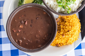 Brazilian feijoada in the bowl on the table