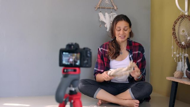 Cheerful young adult girl craft blogger recording online DIY video for the channel in social media.