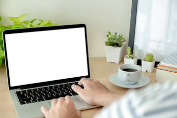 Fototapeta premium mockup image blank screen computer with white background for advertising text,hand man using laptop contact business search information on desk at coffee shop.marketing and creative design
