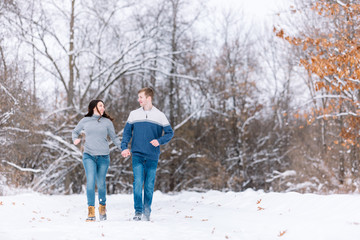 Love Valentine Concept. people, season, love and leisure concept. happy couple walking through the park on a snowy day. Romantic couple in love feeling happiness romance Valentine . love copy space.