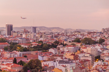 Fototapeta na wymiar Skyline of evening Lisbon from Miradouro da Graca viewpoint, Portugal